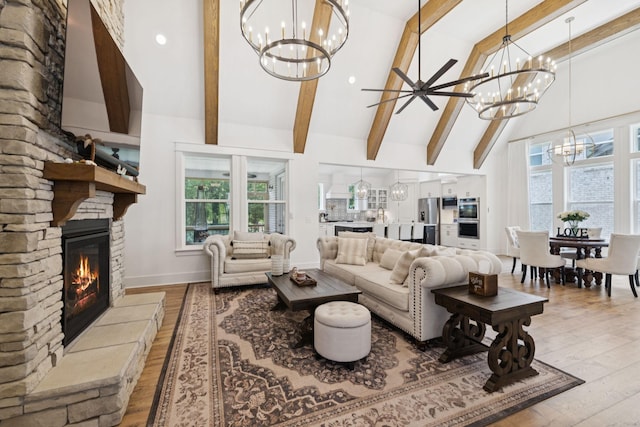 5128 Terravista Ln, Franklin, TN 37064 - living area featuring a chandelier, a fireplace, wood finished floors, beam ceiling, and healthy amount of natural light