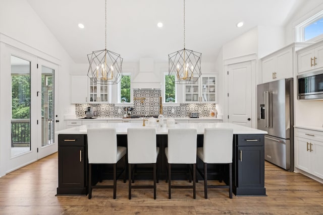 5128 Terravista Ln, Franklin, TN 37064 - kitchen with appliances with stainless steel finishes, custom range hood, vaulted ceiling, a chandelier, and a center island