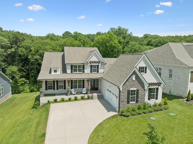 5128 Terravista Ln, Franklin, TN 37064 - shingle-style home featuring a porch, driveway, stone siding, and a front lawn