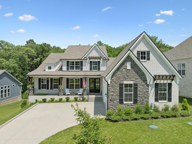5128 Terravista Ln, Franklin, TN 37064 - shingle-style home with a front yard, stone siding, french doors, and a porch