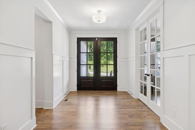 5128 Terravista Ln, Franklin, TN 37064 - foyer with french doors, a decorative wall, wood finished floors, and a wainscoted wall