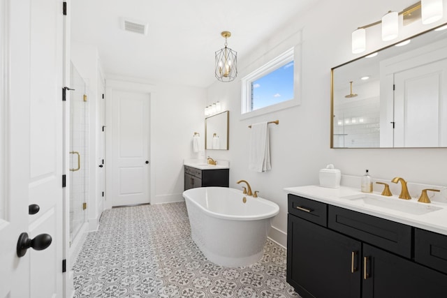 5128 Terravista Ln, Franklin, TN 37064 - bathroom featuring a stall shower, two vanities, a freestanding bath, and a chandelier