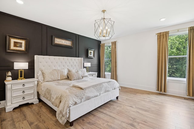 5128 Terravista Ln, Franklin, TN 37064 - bedroom featuring a chandelier, wood finished floors, recessed lighting, and a decorative wall