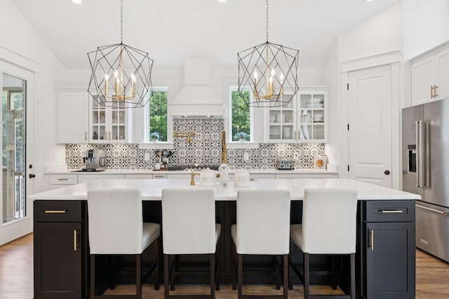 5128 Terravista Ln, Franklin, TN 37064 - kitchen with high end fridge, custom exhaust hood, a chandelier, light countertops, and lofted ceiling