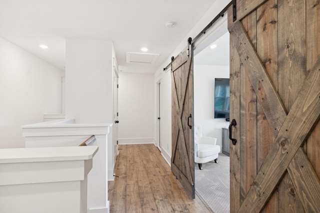 5128 Terravista Ln, Franklin, TN 37064 - hallway featuring a barn door, light wood-style flooring, and recessed lighting