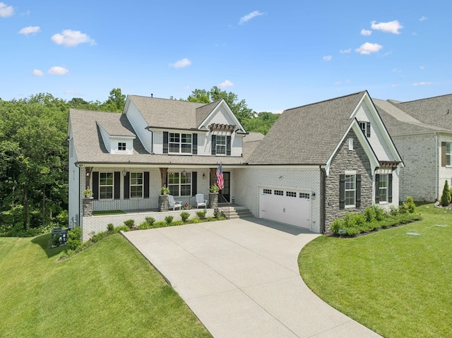 5128 Terravista Ln, Franklin, TN 37064 - view of front of home with covered porch, a garage, concrete driveway, a front lawn, and brick siding