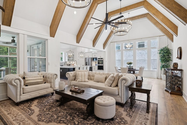 5128 Terravista Ln, Franklin, TN 37064 - living room with a chandelier, beamed ceiling, healthy amount of natural light, wood finished floors, and high vaulted ceiling