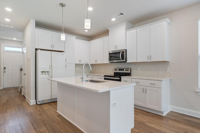 270 Netherlands Blvd, Lebanon, TN 37090 - kitchen featuring appliances with stainless steel finishes, light wood-type flooring, decorative backsplash, white cabinets, and recessed lighting