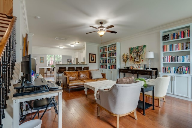 2003 Rural Plains Cir, Franklin, TN 37064 - living room featuring light wood finished floors, ornamental molding, a ceiling fan, stairs, and a desk