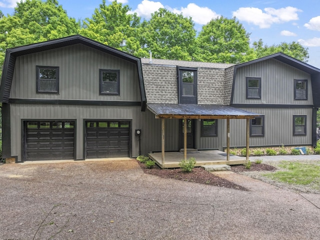 7121 Robinson Dr, Fairview, TN 37062 - colonial inspired home with a shingled roof, a garage, a gambrel roof, driveway, and covered porch