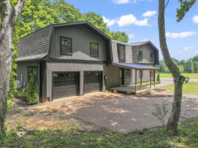 7121 Robinson Dr, Fairview, TN 37062 - view of front of home featuring a gambrel roof, dirt driveway, a garage, and roof with shingles