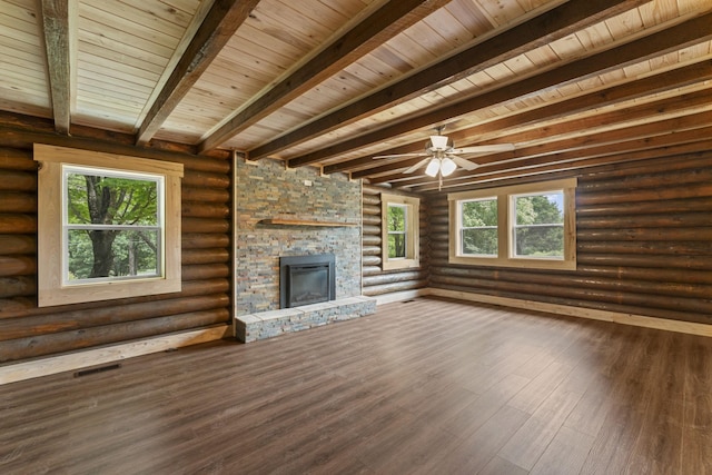 7121 Robinson Dr, Fairview, TN 37062 - unfurnished living room featuring a stone fireplace, healthy amount of natural light, wood finished floors, rustic walls, and a wood ceiling with exposed beams