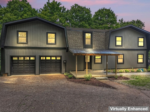 7121 Robinson Dr, Fairview, TN 37062 - view of front of property featuring a shingled roof, a gambrel roof, a garage, driveway, and a porch