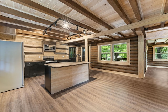 7121 Robinson Dr, Fairview, TN 37062 - kitchen with appliances with stainless steel finishes, light wood-type flooring, rustic walls, an island with sink, and a wood ceiling with exposed beams