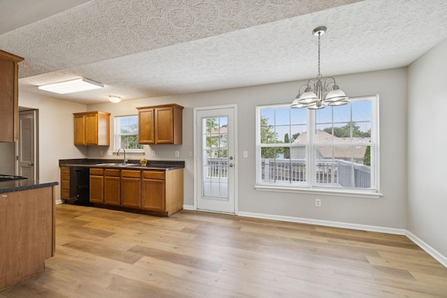 1882 Portway Rd, Spring Hill, TN 37174 - kitchen featuring dishwasher, light wood-type flooring, brown cabinetry, a chandelier, and a textured ceiling