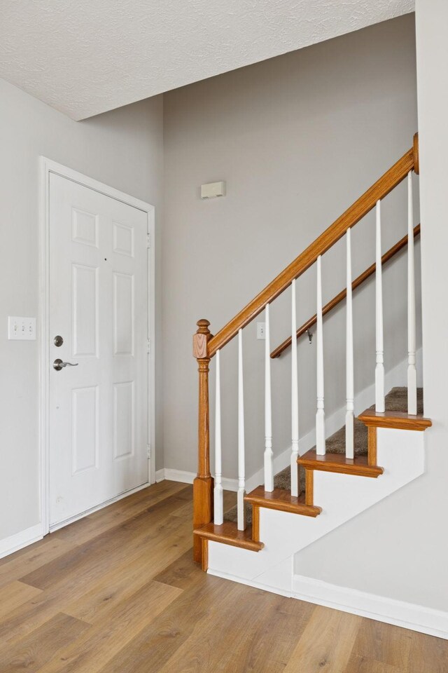 1882 Portway Rd, Spring Hill, TN 37174 - entryway with wood finished floors, stairs, and a textured ceiling