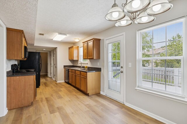 1882 Portway Rd, Spring Hill, TN 37174 - kitchen featuring a textured ceiling, dark countertops, brown cabinetry, light wood finished floors, and a chandelier