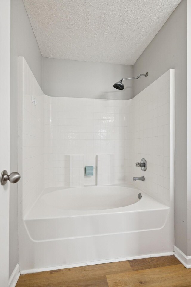 1882 Portway Rd, Spring Hill, TN 37174 - bathroom featuring wood finished floors, a textured ceiling, and shower / bathtub combination