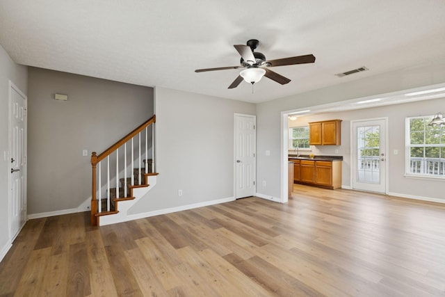 1882 Portway Rd, Spring Hill, TN 37174 - unfurnished living room featuring light wood-type flooring, a ceiling fan, and stairway