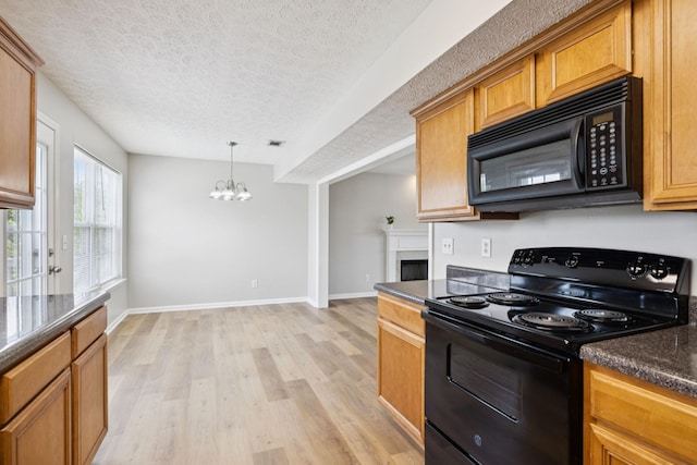 1882 Portway Rd, Spring Hill, TN 37174 - kitchen featuring black appliances, a chandelier, light wood-style floors, a textured ceiling, and brown cabinetry
