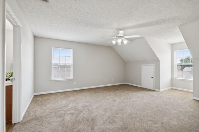 1882 Portway Rd, Spring Hill, TN 37174 - bonus room featuring carpet flooring, healthy amount of natural light, ceiling fan, vaulted ceiling, and a textured ceiling