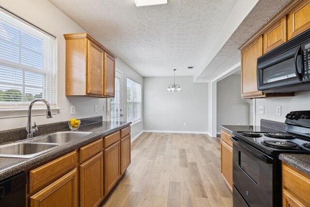1882 Portway Rd, Spring Hill, TN 37174 - kitchen featuring black appliances, dark countertops, light wood-style floors, a textured ceiling, and a chandelier