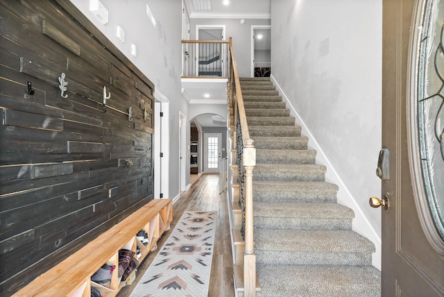 1613 Kestrel Dr, Clarksville, TN 37040 - entryway featuring ornamental molding, arched walkways, stairs, a towering ceiling, and wood finished floors