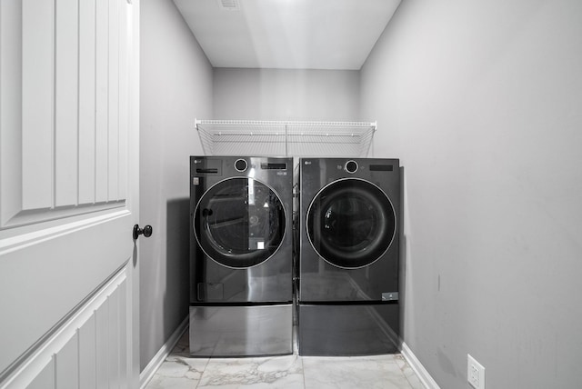 1613 Kestrel Dr, Clarksville, TN 37040 - washroom with washing machine and dryer and marble look tile flooring