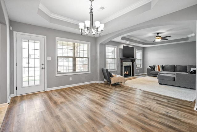 1613 Kestrel Dr, Clarksville, TN 37040 - living area with a tray ceiling, plenty of natural light, wood finished floors, ornamental molding, and a chandelier
