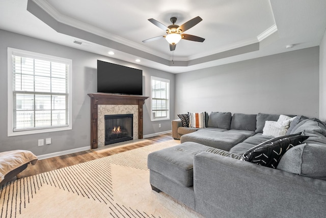 1613 Kestrel Dr, Clarksville, TN 37040 - living area with a tray ceiling, wood finished floors, ornamental molding, ceiling fan, and a fireplace