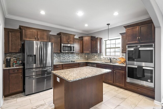 1613 Kestrel Dr, Clarksville, TN 37040 - kitchen with stainless steel appliances, light marble finish flooring, dark brown cabinetry, light stone counters, and a kitchen island