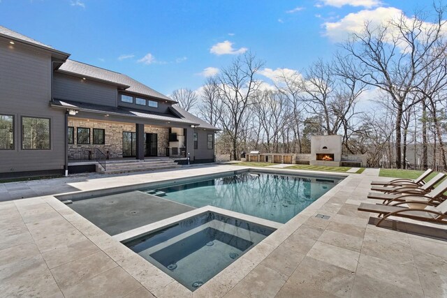 6128 Lookaway Cir, Franklin, TN 37067 - view of pool featuring a patio, an in-ground hot tub, and a lit fireplace