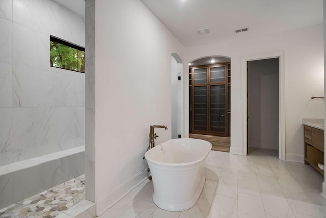 6128 Lookaway Cir, Franklin, TN 37067 - bathroom with a freestanding bath, vanity, marble look tiles, and a shower