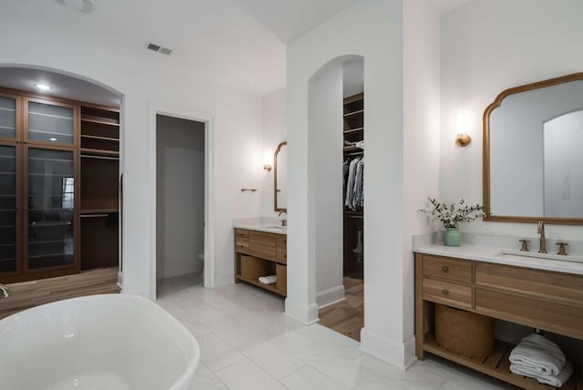 6128 Lookaway Cir, Franklin, TN 37067 - full bathroom featuring a freestanding tub, a walk in closet, vanity, and marble finish flooring