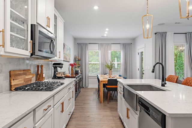 1003 Autumn Ridge Ct, Spring Hill, TN 37174 - kitchen featuring stainless steel appliances, recessed lighting, light wood-style flooring, decorative backsplash, and white cabinetry