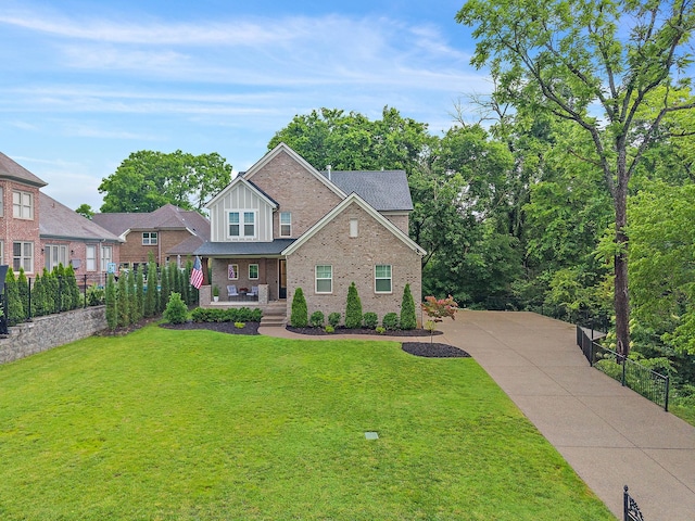 1003 Autumn Ridge Ct, Spring Hill, TN 37174 - view of front of home featuring covered porch, brick siding, board and batten siding, and concrete driveway