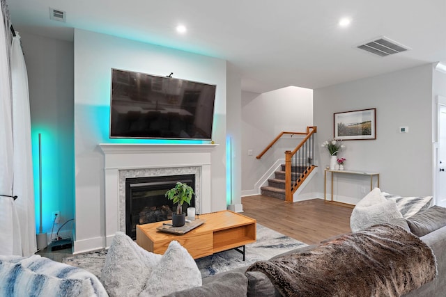 1003 Autumn Ridge Ct, Spring Hill, TN 37174 - living room featuring stairs, wood finished floors, a premium fireplace, and recessed lighting