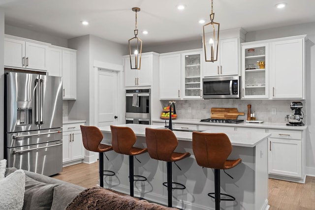 1003 Autumn Ridge Ct, Spring Hill, TN 37174 - kitchen with stainless steel appliances, recessed lighting, backsplash, and light wood-style flooring