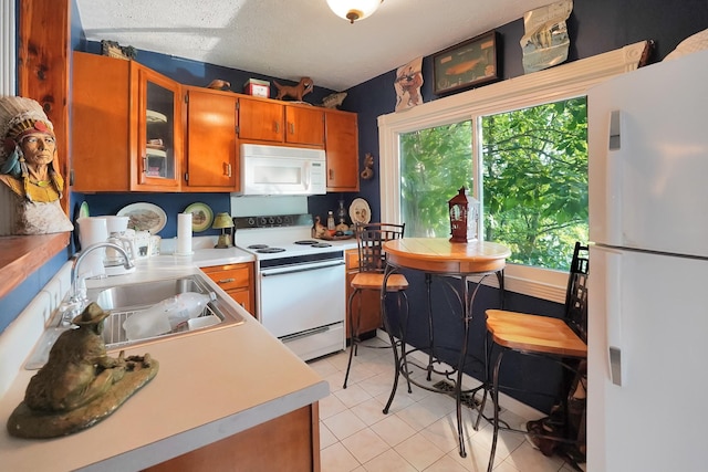 211 Lewis Cir, Dover, TN 37058 - kitchen featuring white appliances, brown cabinets, light countertops, glass insert cabinets, and light tile patterned floors