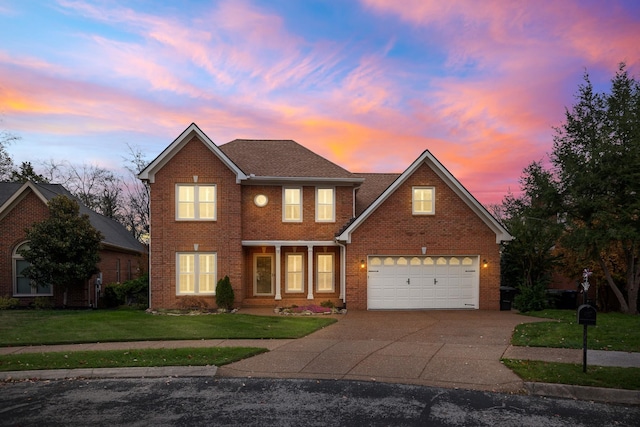 324 Julianna Cir, Franklin, TN 37064 - traditional-style home with a lawn, brick siding, driveway, and an attached garage