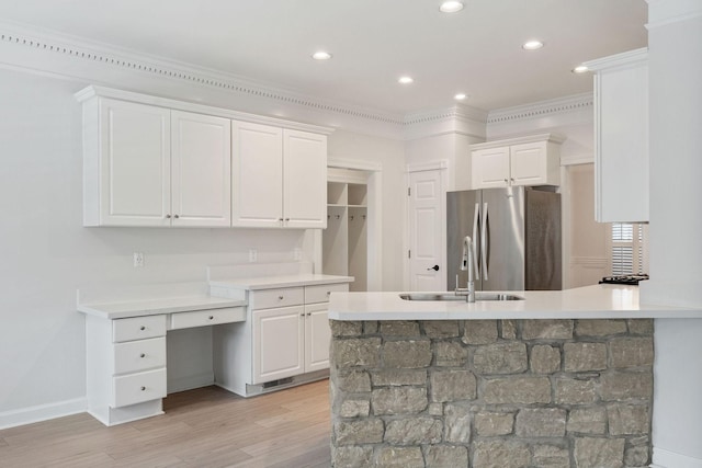 324 Julianna Cir, Franklin, TN 37064 - kitchen with freestanding refrigerator, white cabinets, light wood finished floors, light countertops, and a peninsula