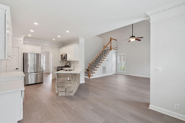 324 Julianna Cir, Franklin, TN 37064 - kitchen with stainless steel appliances, a ceiling fan, white cabinetry, light countertops, and crown molding