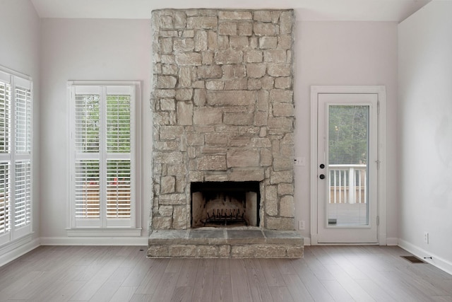 324 Julianna Cir, Franklin, TN 37064 - unfurnished living room featuring a fireplace, wood finished floors, and healthy amount of natural light