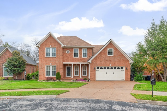 324 Julianna Cir, Franklin, TN 37064 - view of front facade with brick siding, a front yard, driveway, and a garage