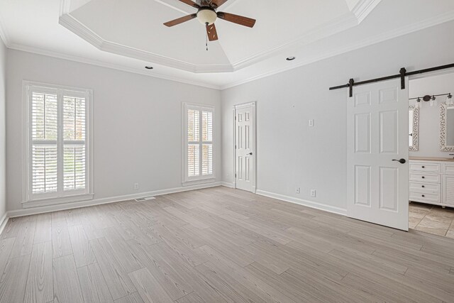 324 Julianna Cir, Franklin, TN 37064 - unfurnished room featuring a raised ceiling, a barn door, a ceiling fan, healthy amount of natural light, and crown molding