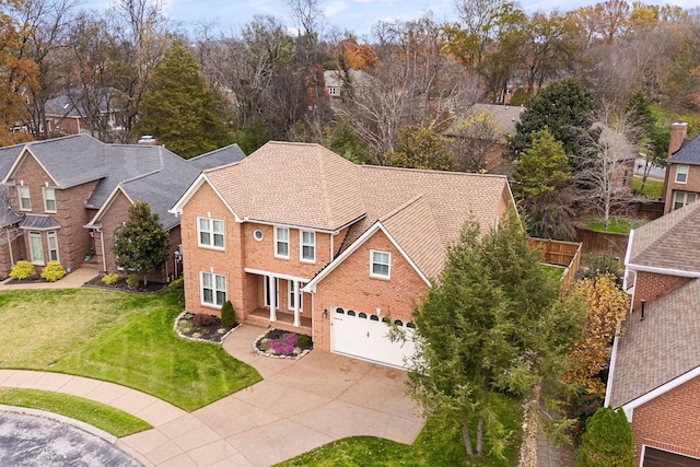 324 Julianna Cir, Franklin, TN 37064 - view of front of property featuring concrete driveway, a front yard, a residential view, and brick siding