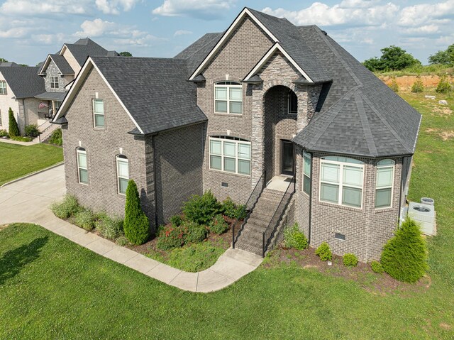160 Dobson Knob Trl, Nolensville, TN 37135 - view of front facade with brick siding, a front yard, and roof with shingles