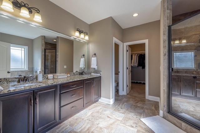 160 Dobson Knob Trl, Nolensville, TN 37135 - bathroom featuring a stall shower, double vanity, a walk in closet, and recessed lighting