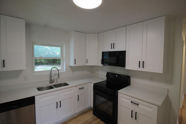 151 Dawn St, Morrison, TN 37357 - kitchen with black appliances, white cabinetry, and light countertops