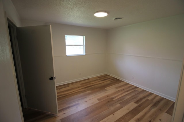 151 Dawn St, Morrison, TN 37357 - spare room featuring wood finished floors and a textured ceiling